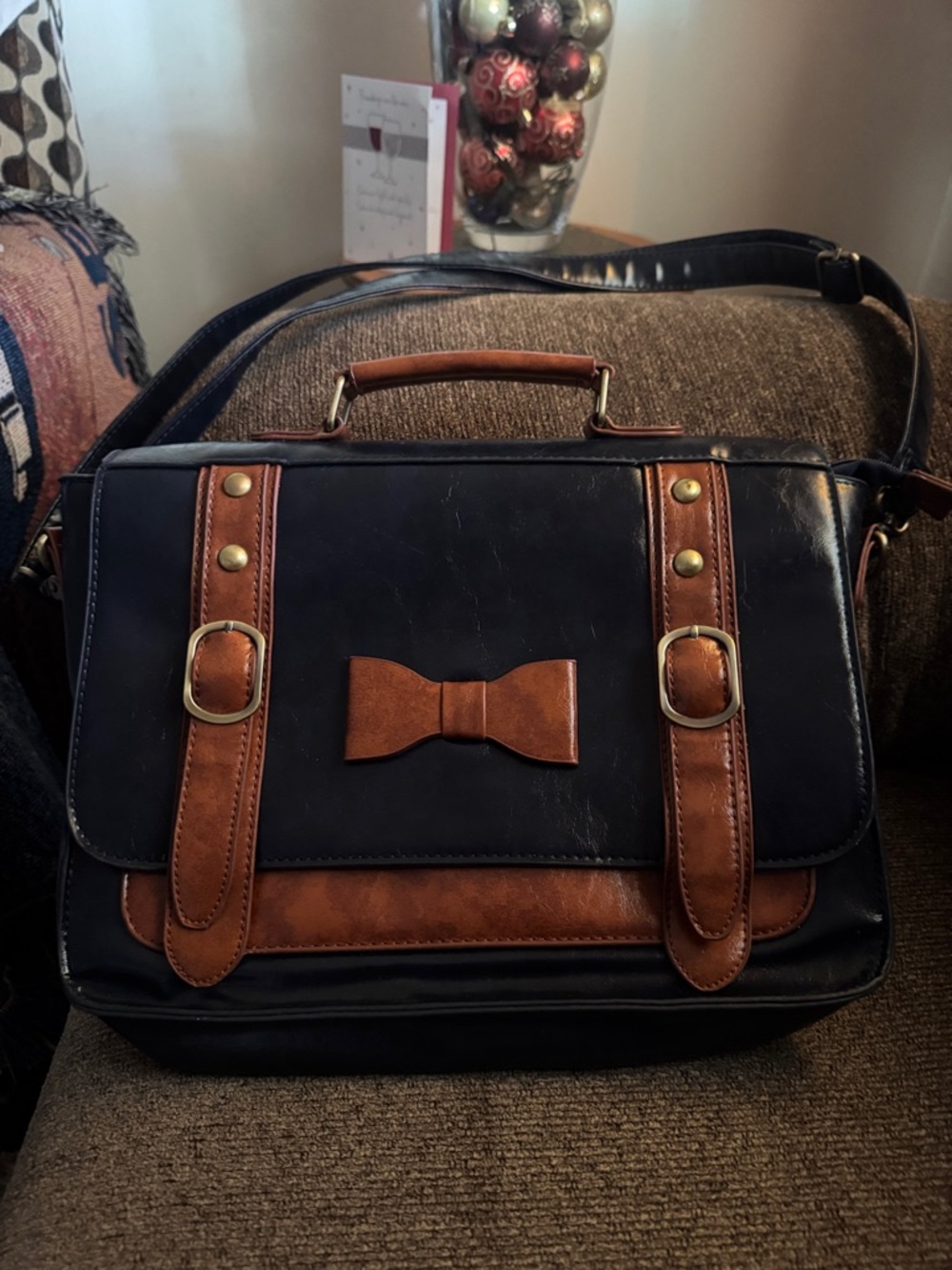 Blue and Brown Leather-Accent  Bag with Bow Detail it is blue and brown,